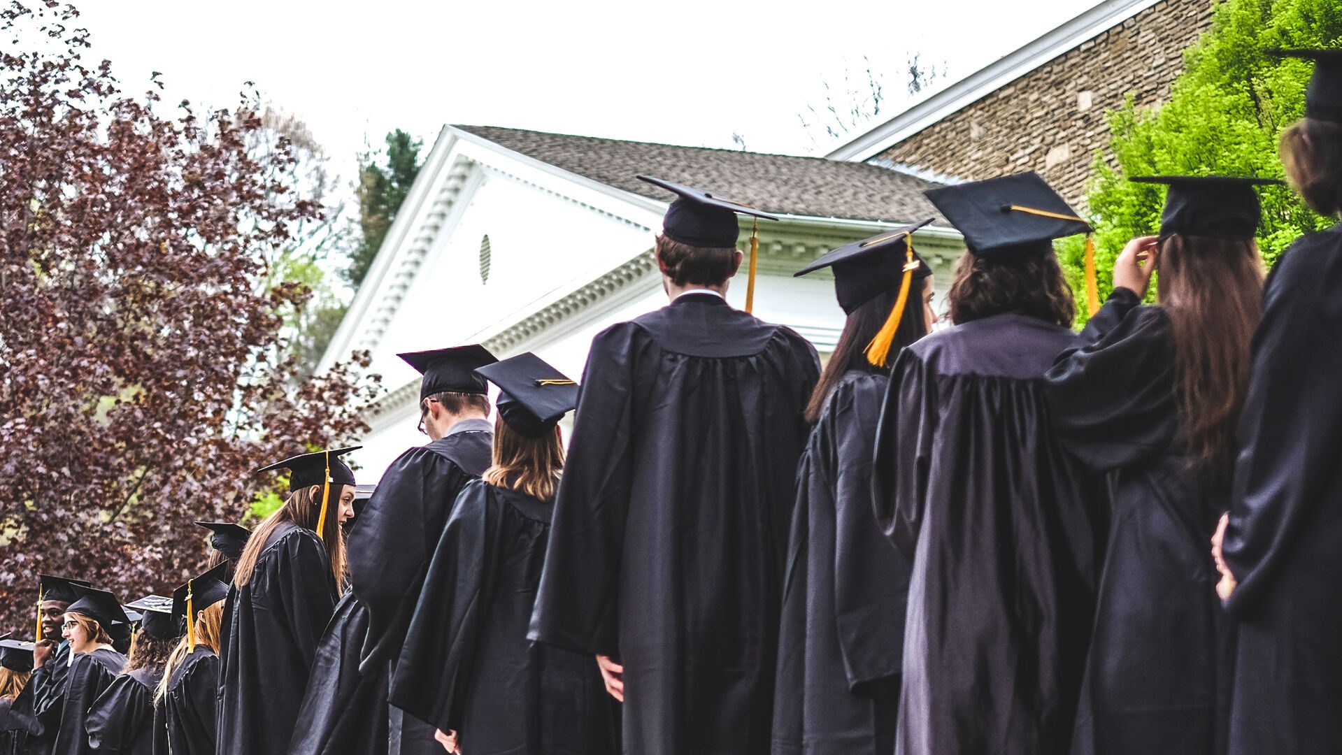 graduates lined up outside in front of chapel at commencement