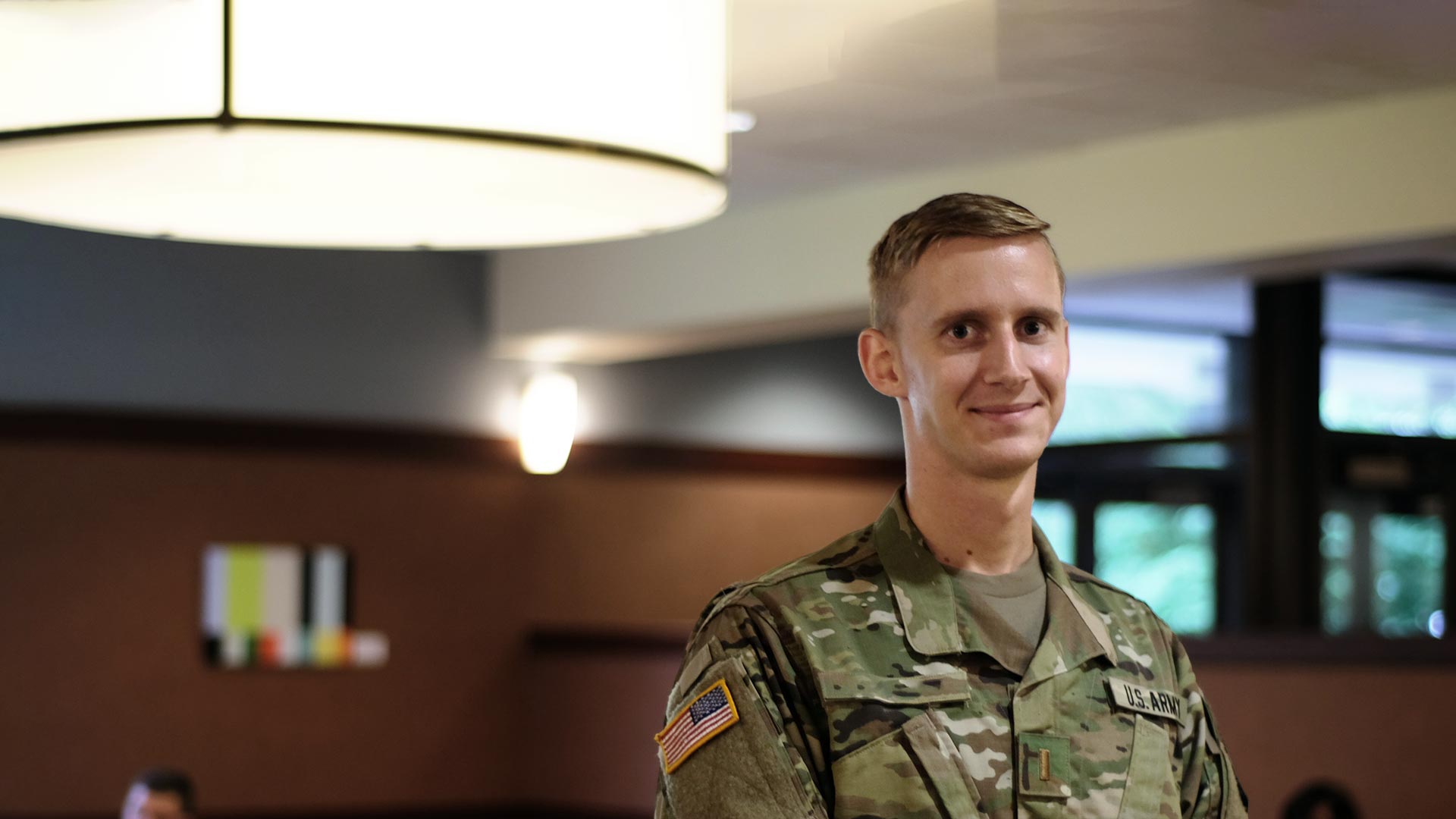 Army ROTC cadet in fatigues looking at camera