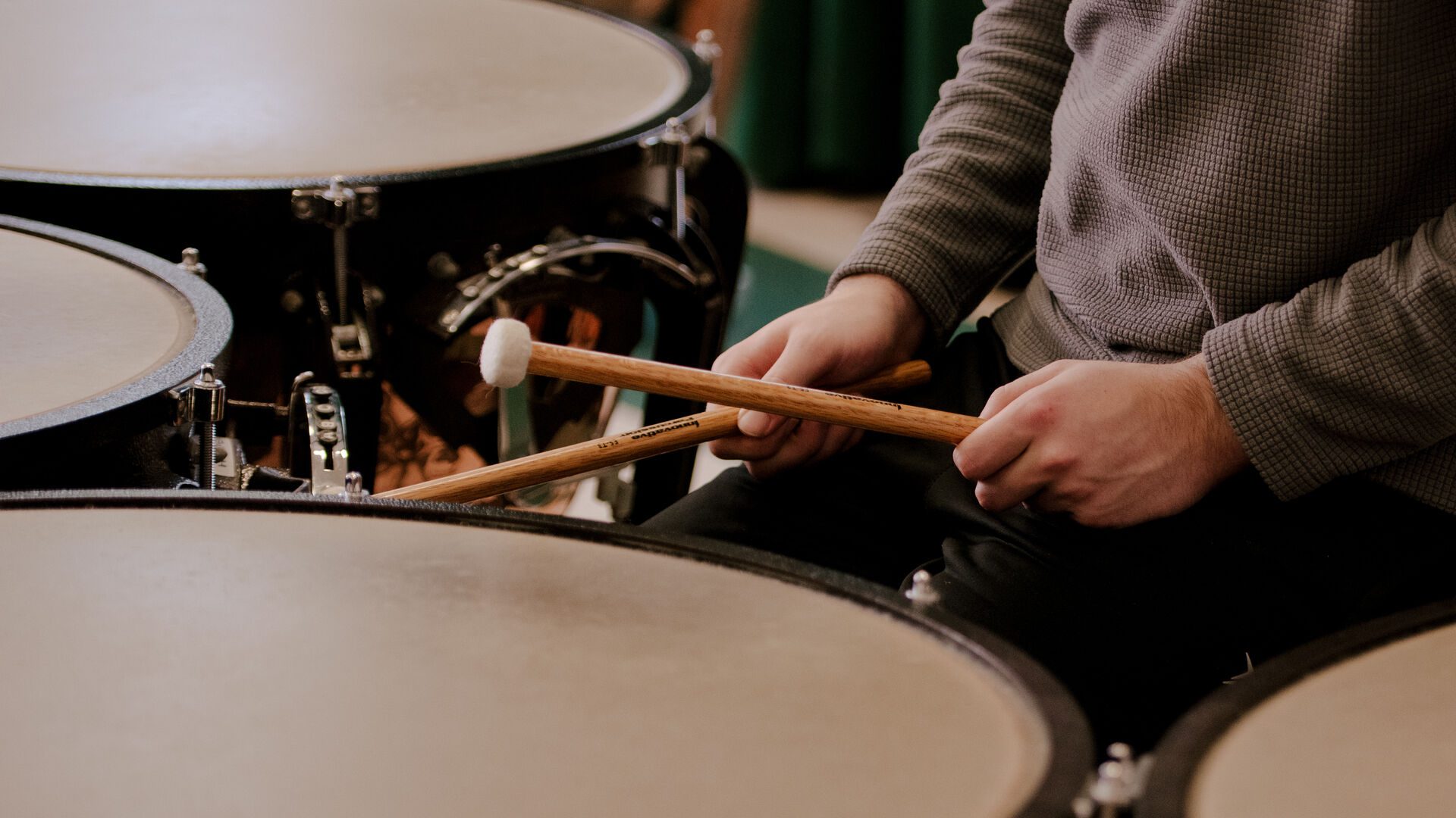 Houghton Universitystudent playing percussion in the wind ensemble.