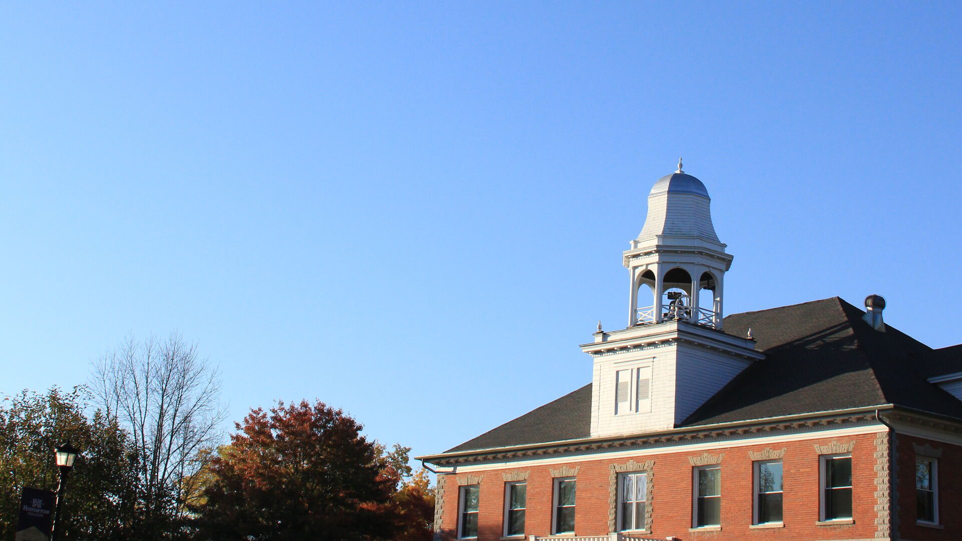The top of Fancher Hall on a beautiful sunny blue sky day.