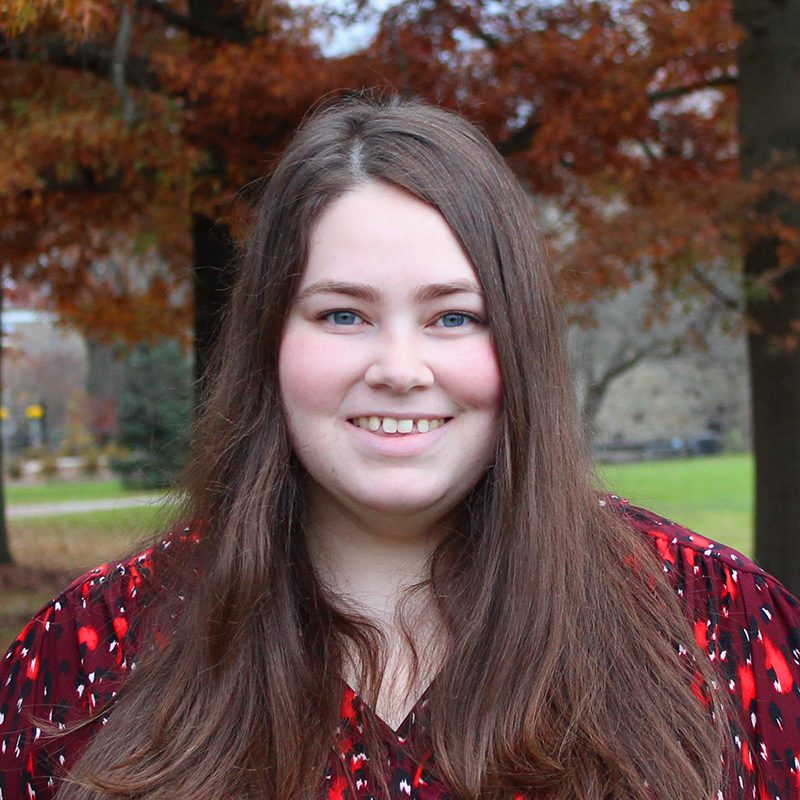 Kaleigh Kenney standing outside on ����ר��'s campus on a fall day.