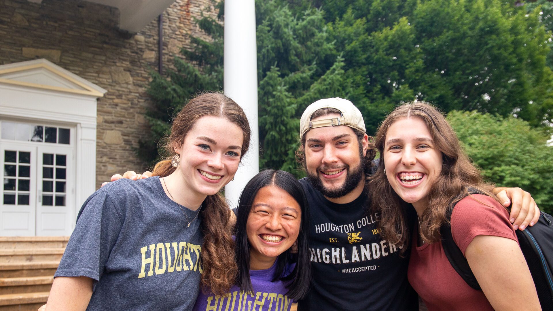 Four ����ר�� students standing together in front of the Wesley Chapel.