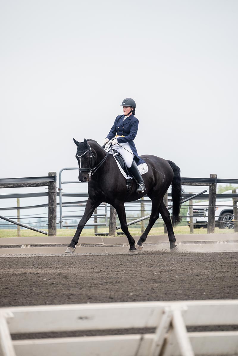 Houghton Universityprofessor Larissa Ries riding horse at Equestrian Center.