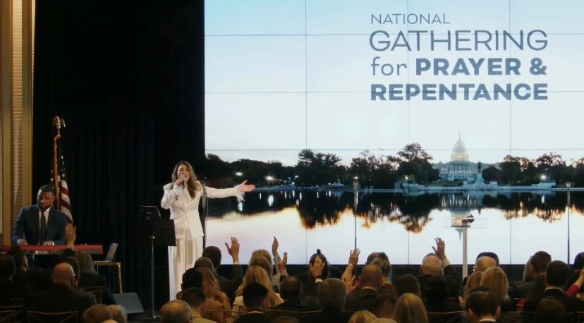 Woman singing on stage during the National Day of Prayer.