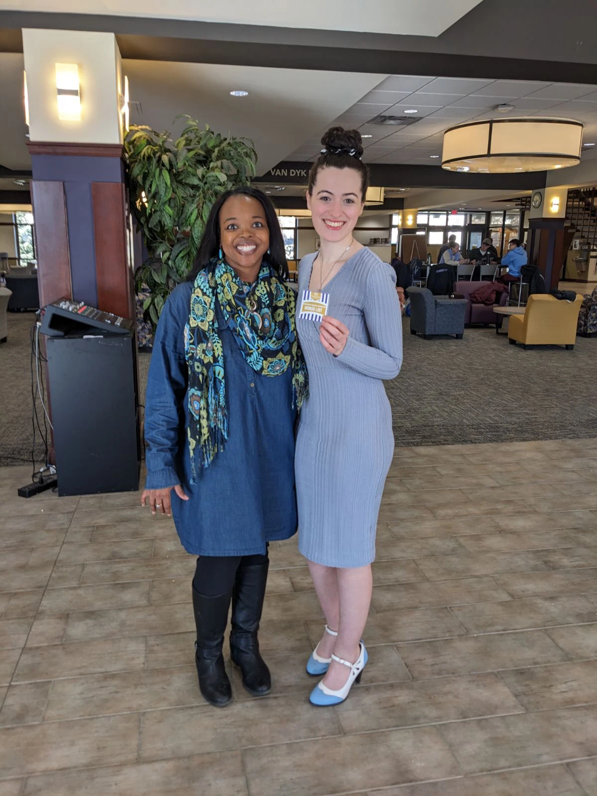 Houghton Universityacademic honors student standing with Monica Lewis.
