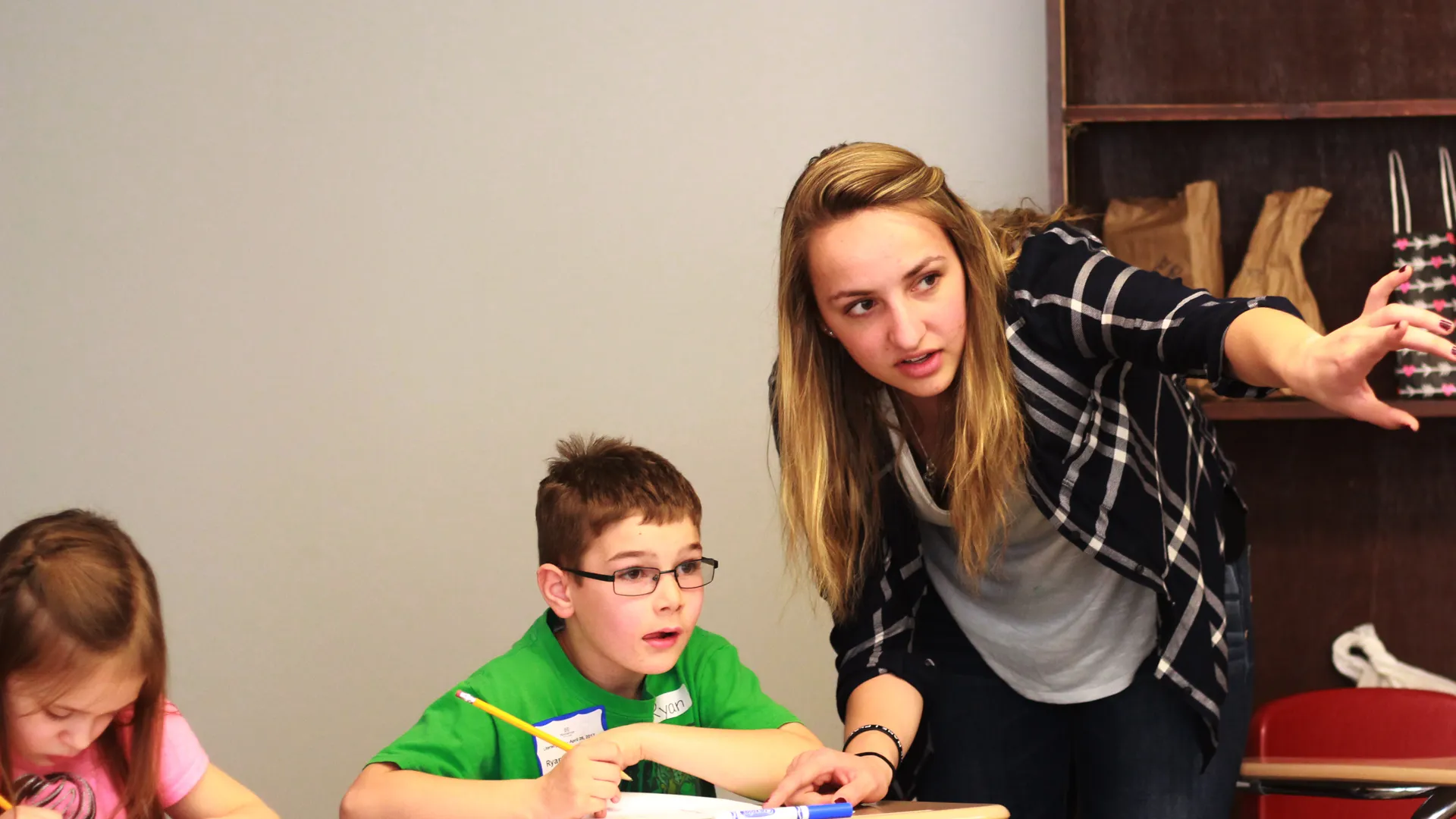 Houghton education major working with student during Literacy Day.