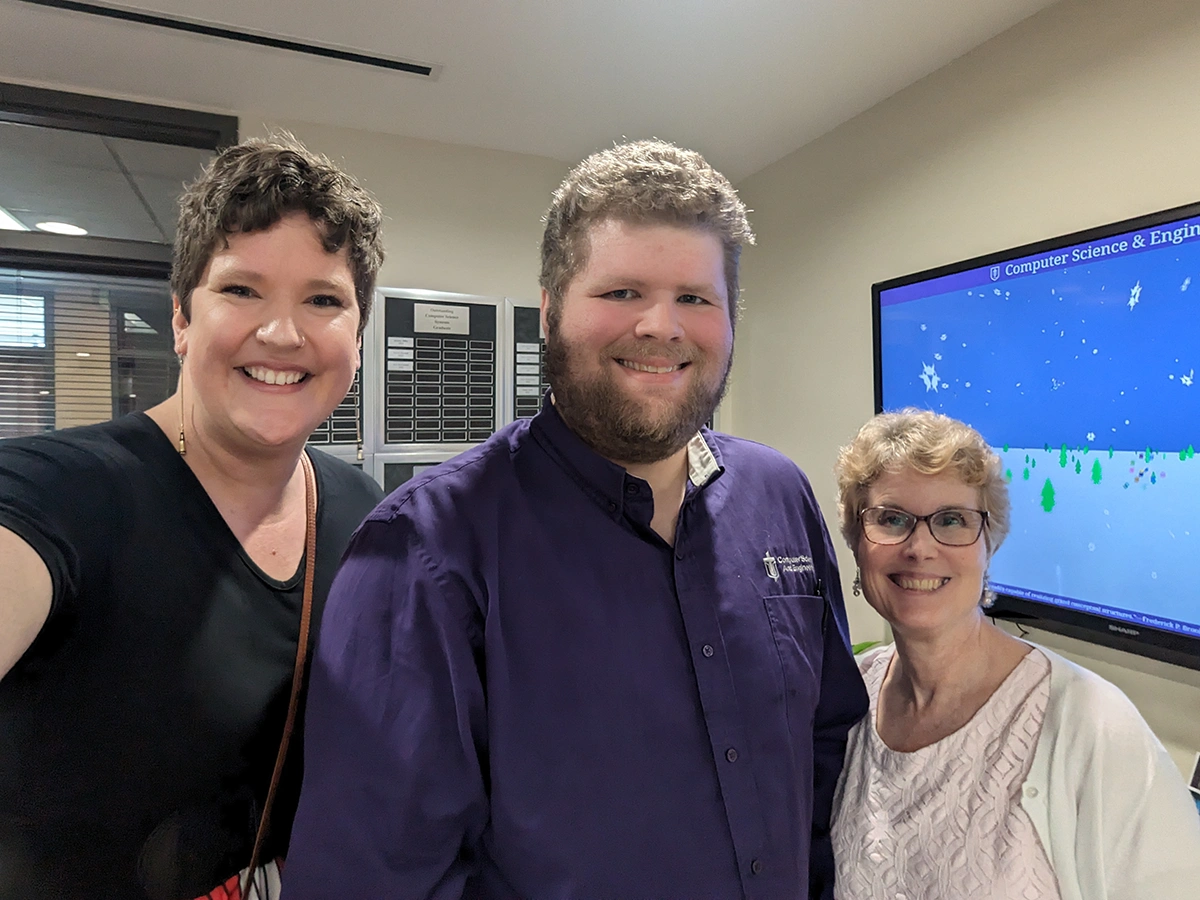 Houghton Universityprofessor Katrina Koehler with two alumni at Taylor University.