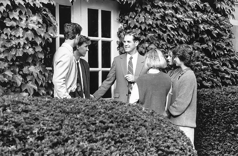 Houghton Universitypresident emeritus Dan Chamberlain speaking with students outside.