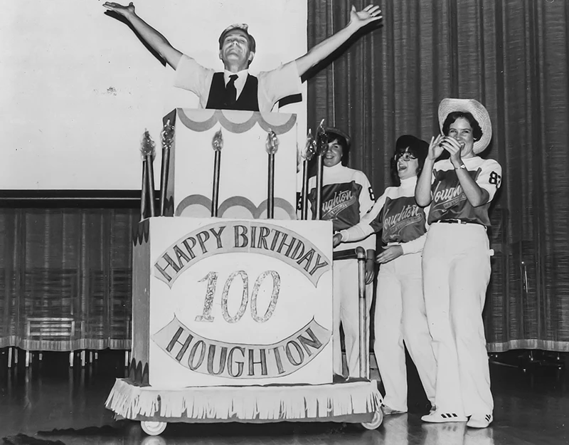 Houghton Universitypresident emeritus Dan Chamberlain jumping out of pretend 100th anniversary cake for ����ר��.