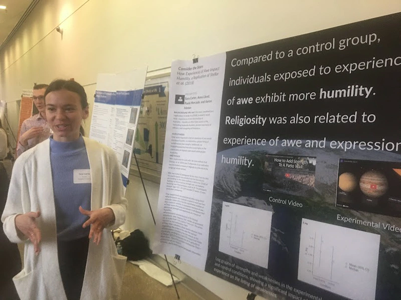 Houghton Universitypsychology student Sara Carter presenting poster at psychology conference.