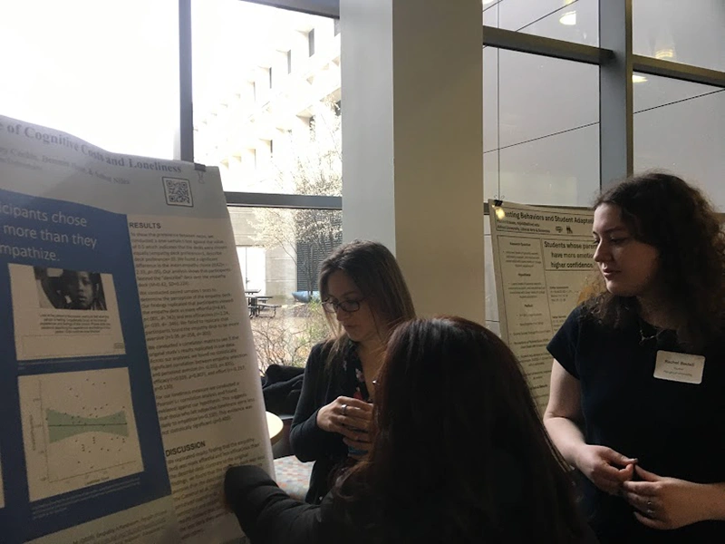 Houghton Universitypsychology student presenting poster at psychology conference.