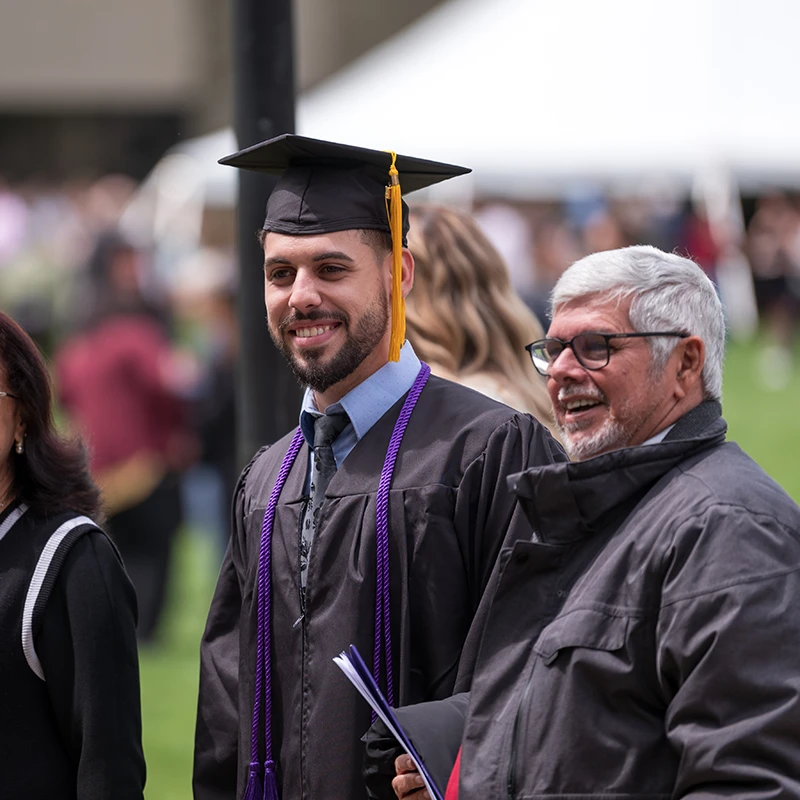 Houghton Universitygraduate standing with father.