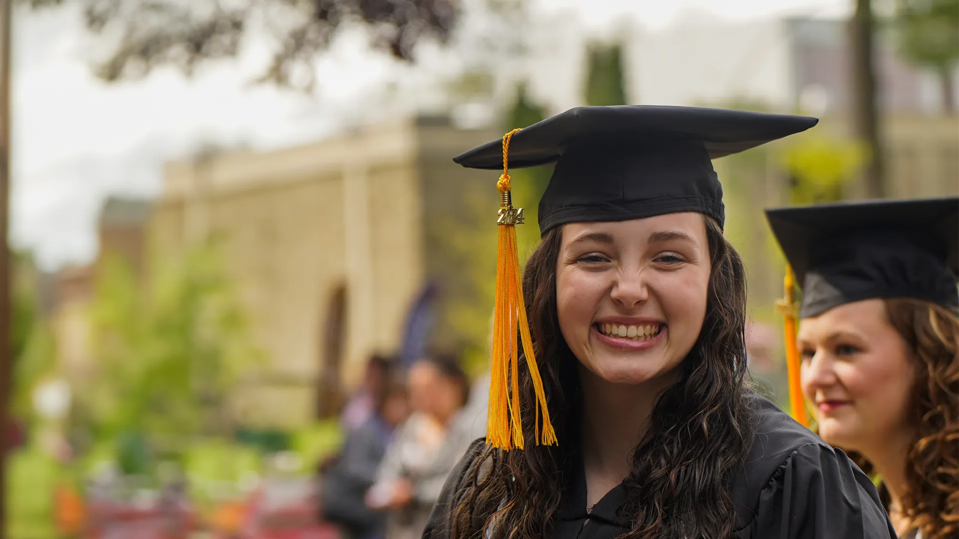 Houghton Universitygraduate with cap and gown.