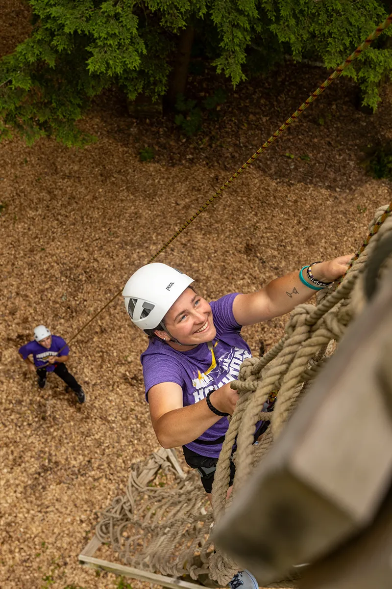 Houghton Universitystudent climbing net on EPIC Adventures Ropes Course.