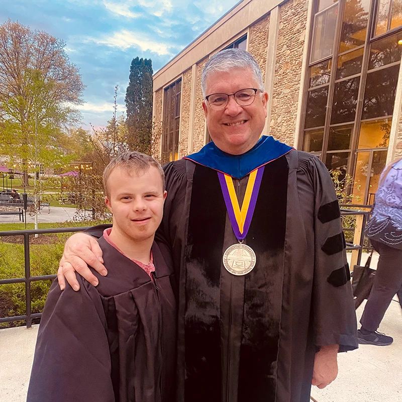 Houghton Universitygraduate standing with professor Douglas Gaerte.