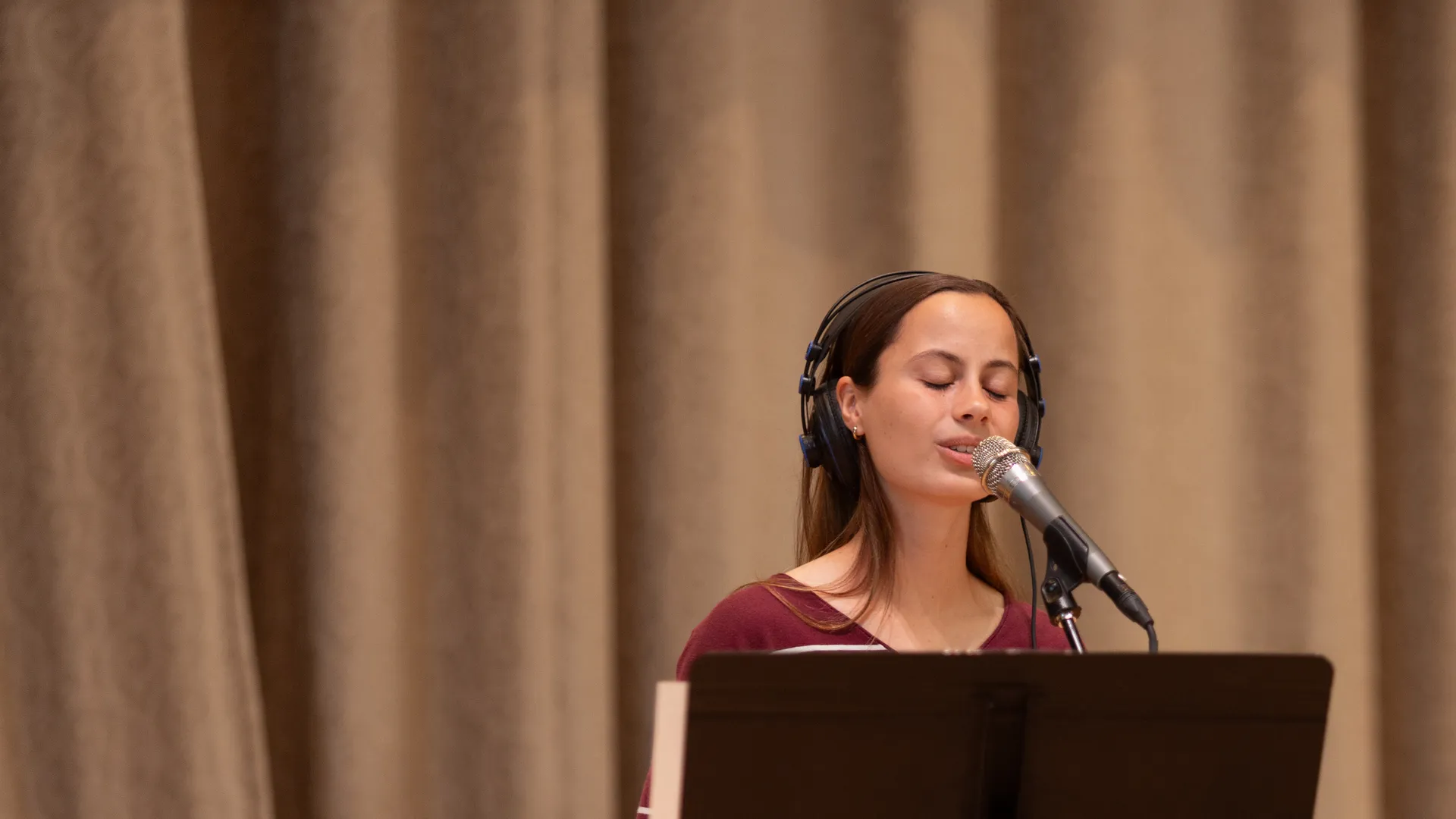 Houghton Universitystudent singing on stage during Chapel.