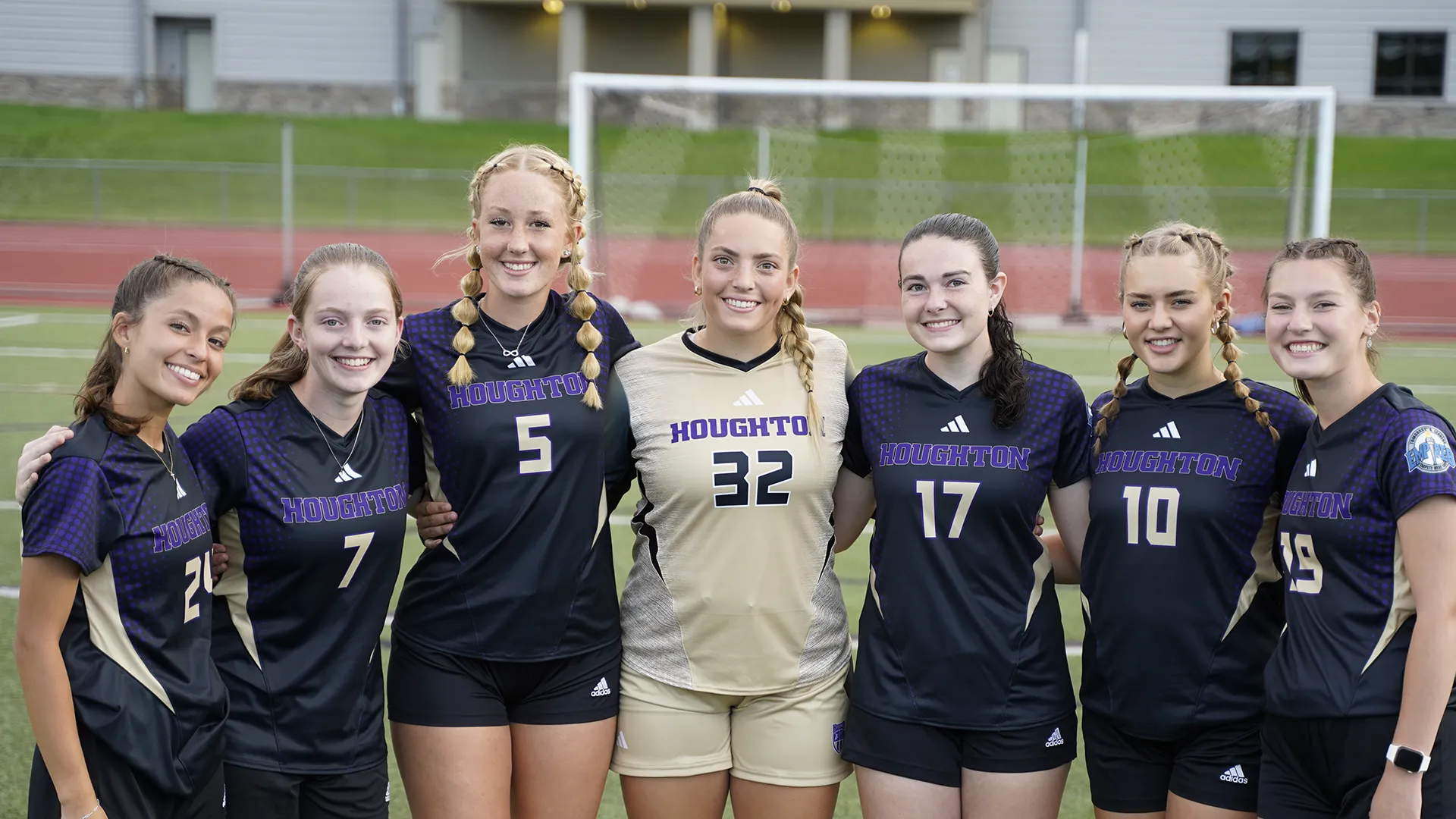 Houghton UniversityWomen's soccer team standing by the goal on the field.