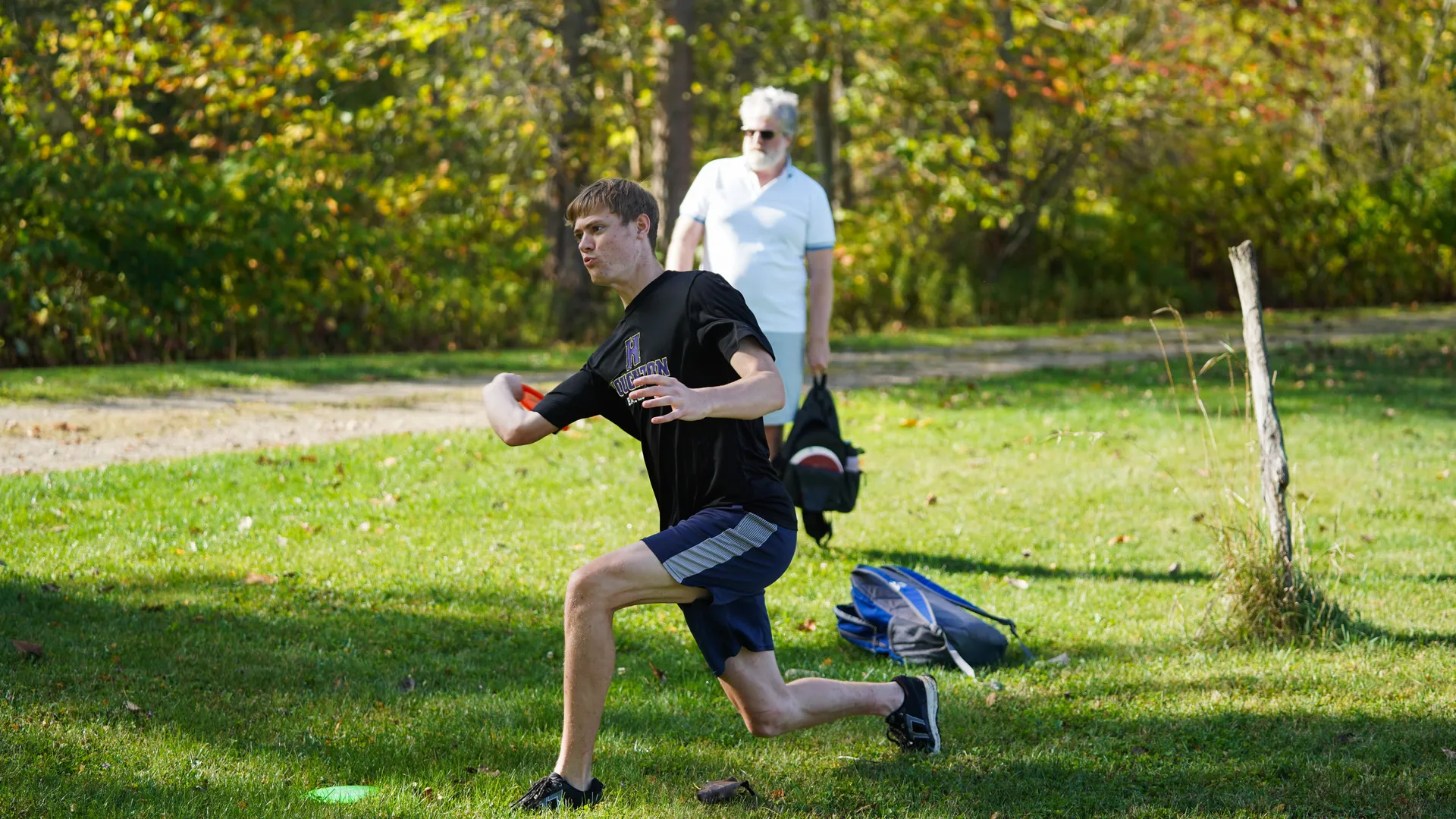 student playing disc golf outside