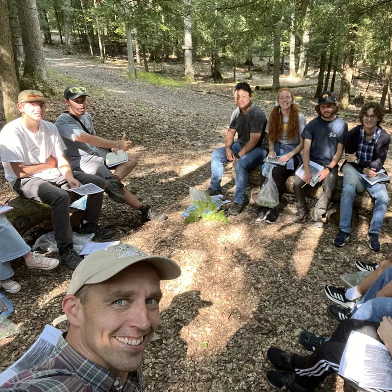Students with professors outside smiling