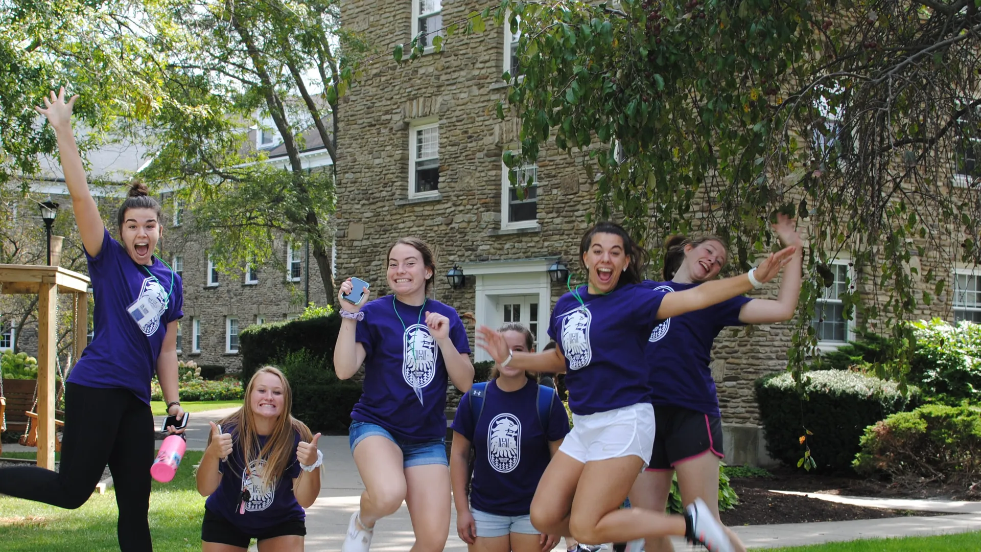 Students jumping up outside East hall