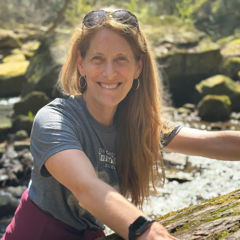 Tania Perkins sitting outside near a stream