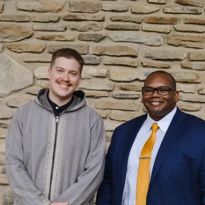 President Lewis and alumni award recipient outside the chapel.