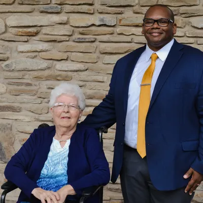 President Lewis and alumni award recipient outside the chapel.