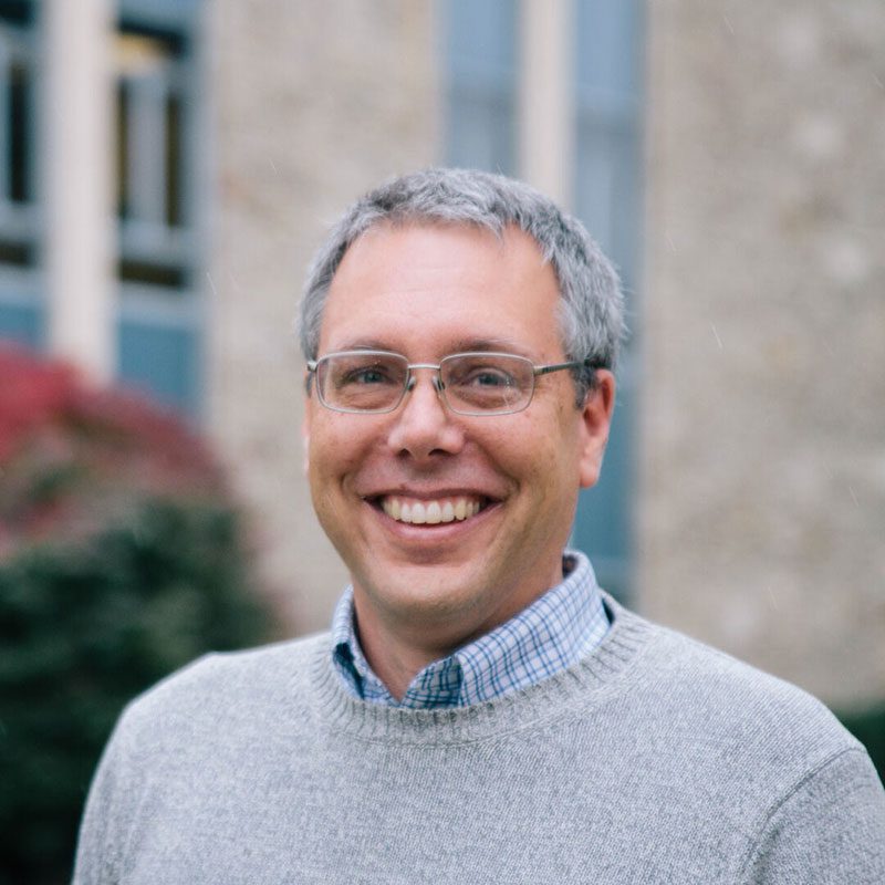 Houghton professor Mark Yuly in gray sweater.
