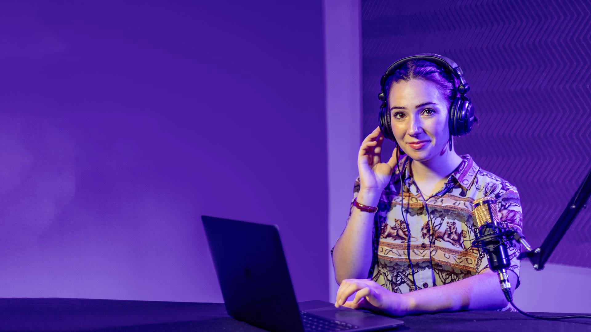 Grace sitting at computer recording podcast