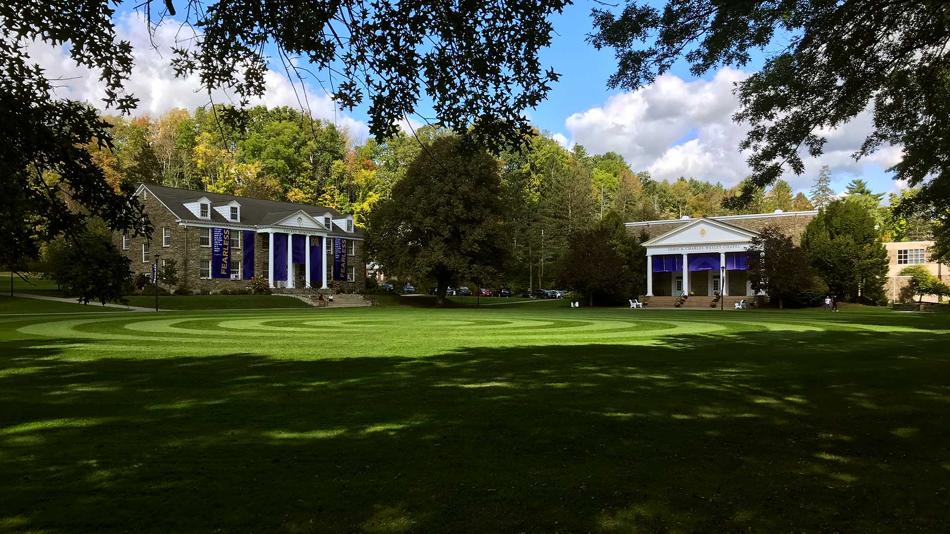 Luckey Building and Wesley Chapel seen across the Quad with purple and gold 