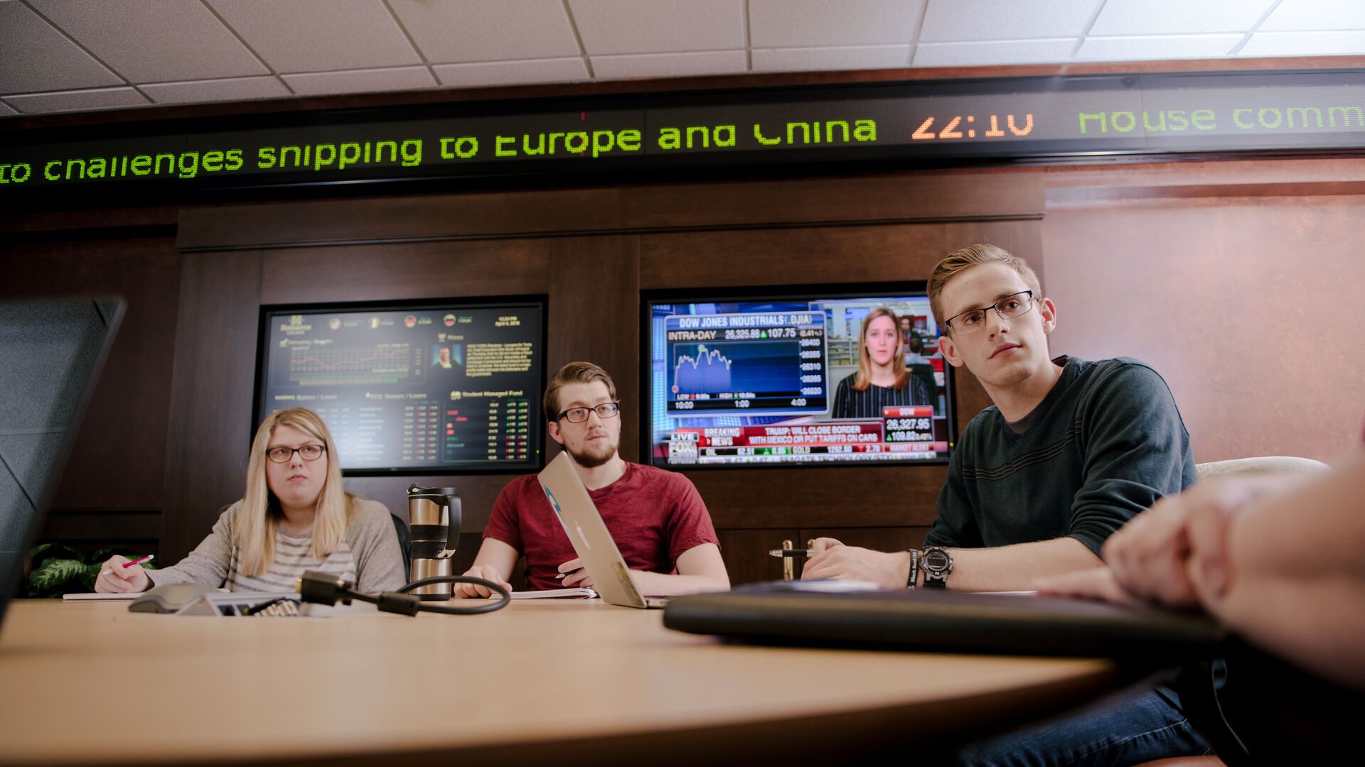 Houghton accounting majors sitting at conference table in investment center.