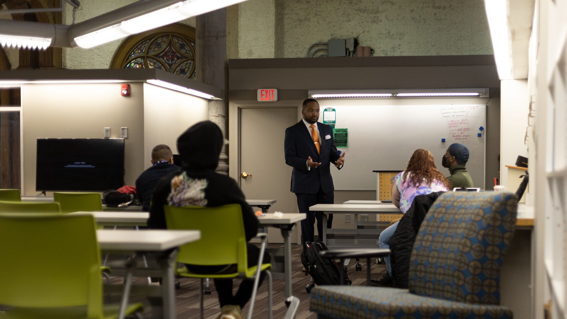 Julian Cook standing at front of classroom