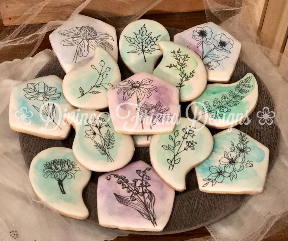 sugar cookies with purple, blue and green flower designs