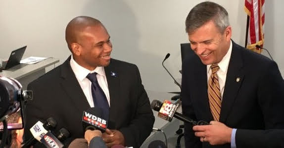 Houghton president Wayne Lewis speaking with Hal Heiner at press conference.