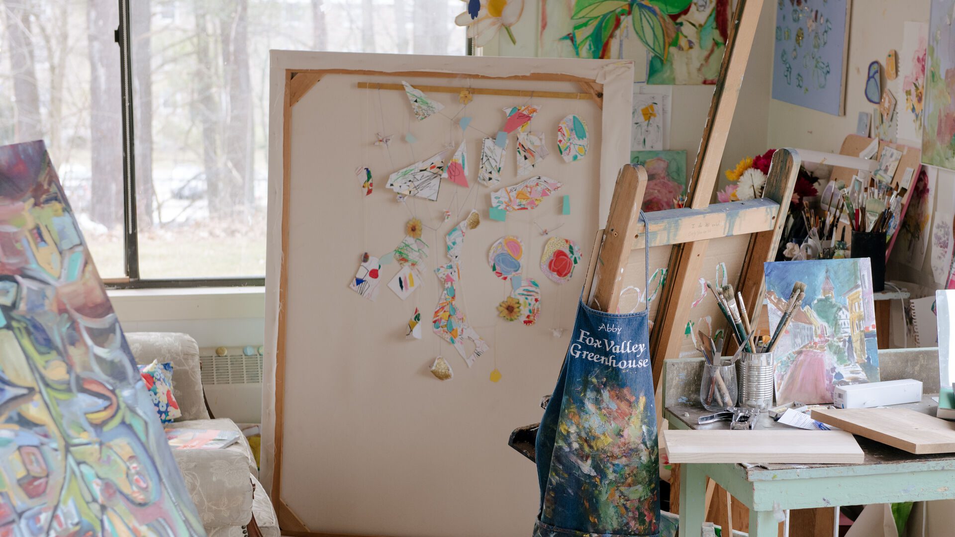View of bfa in painting student's studio space with artwork and supplies displayed.