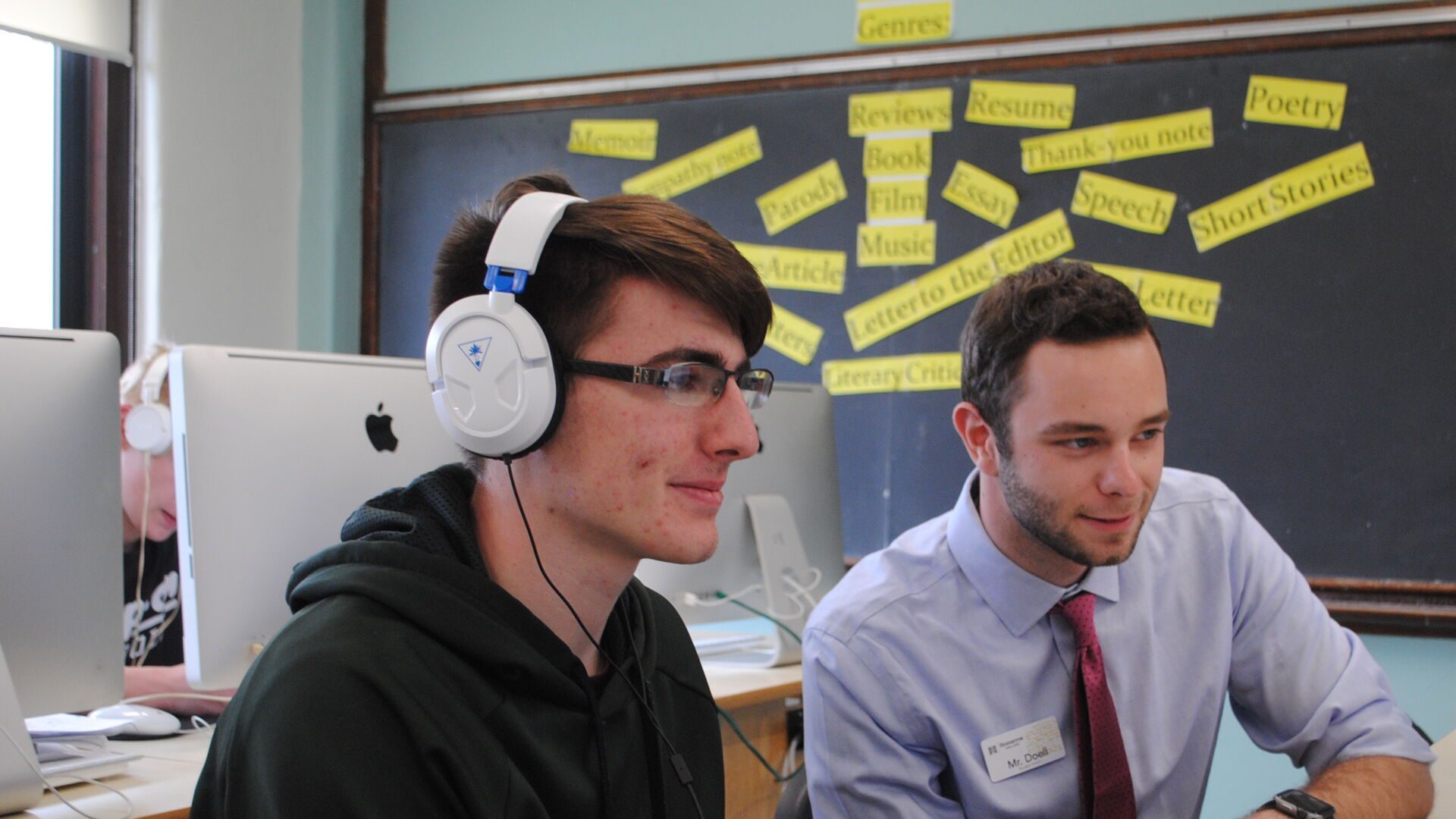 Houghton education major working with high school student at computer.