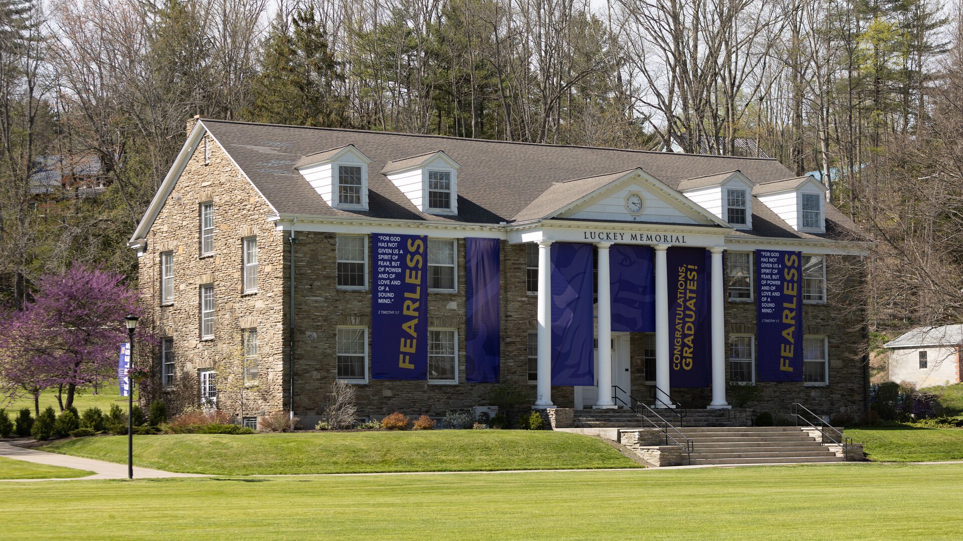 Luckey Memorial Building with purple banners for commencement.