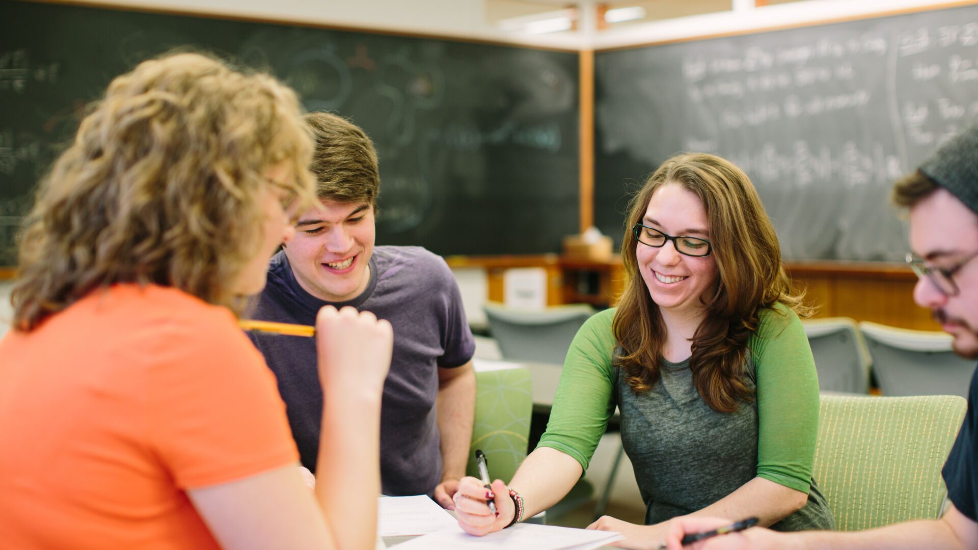 Students working together during class at table.