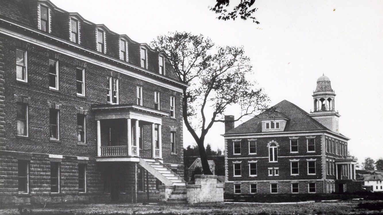 Historic black and white photo of Fancher Hall next to a dormitory building at ���Ͽ�.