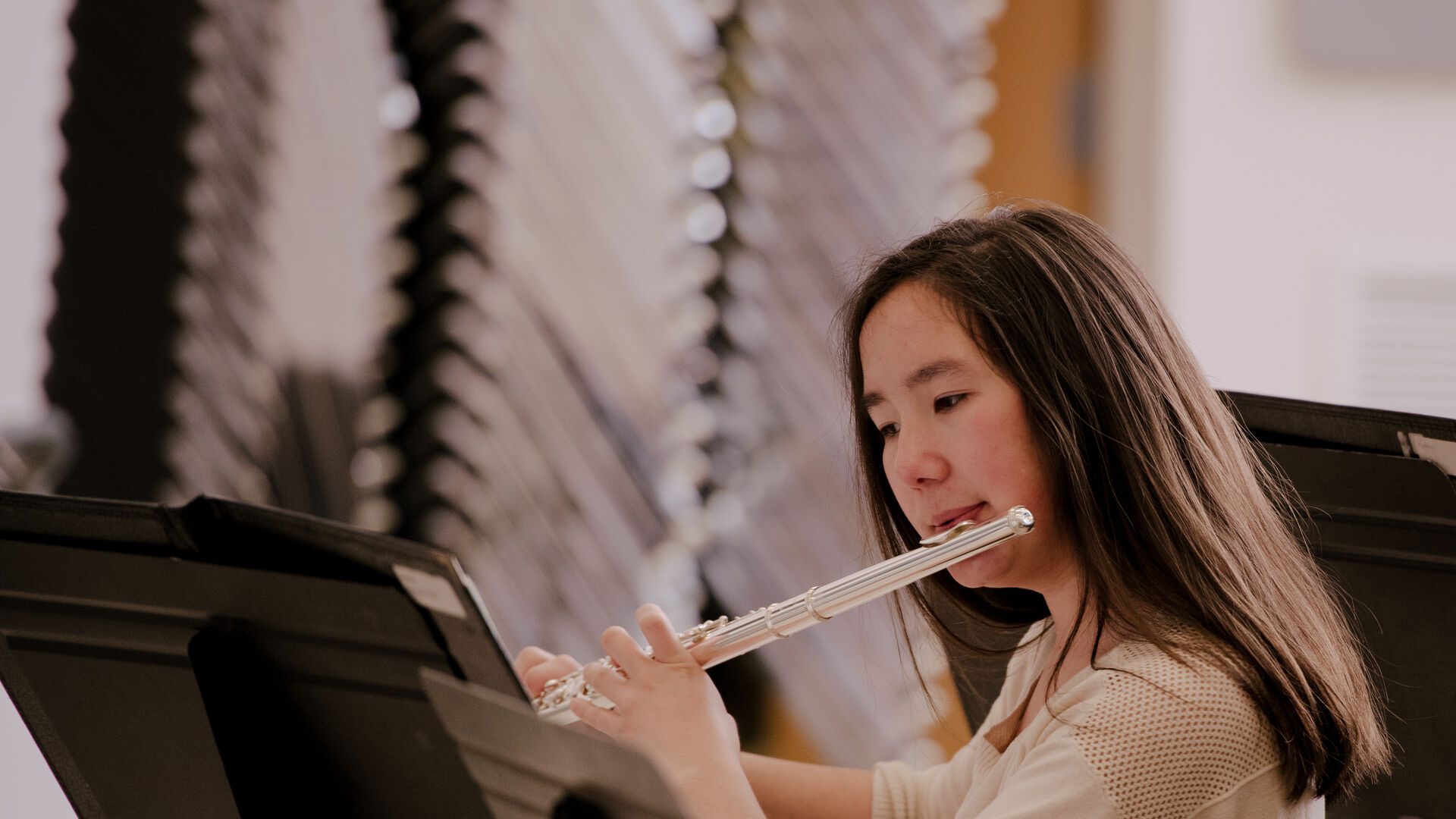 Student in the wind ensemble playing the flute.