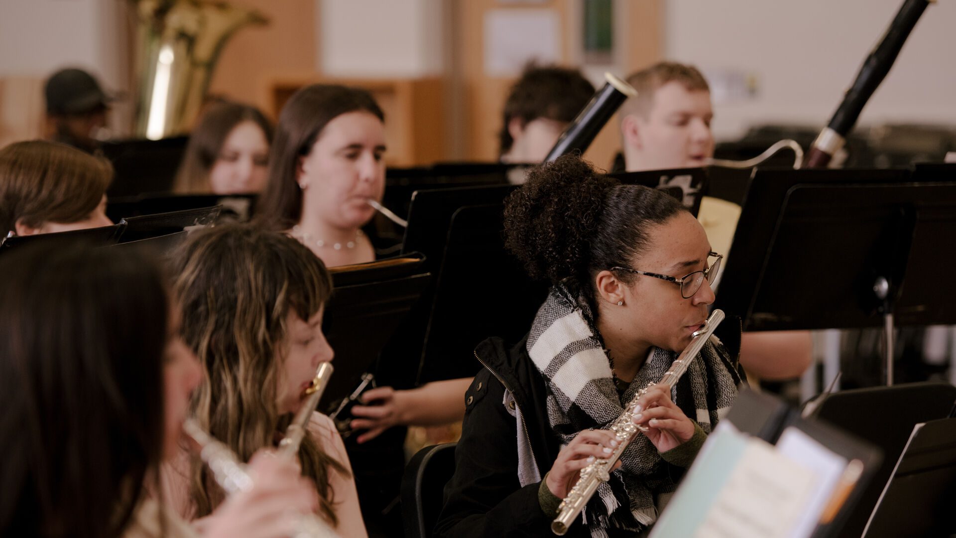 Student playing flutes and bassoons as part of the wind ensemble.