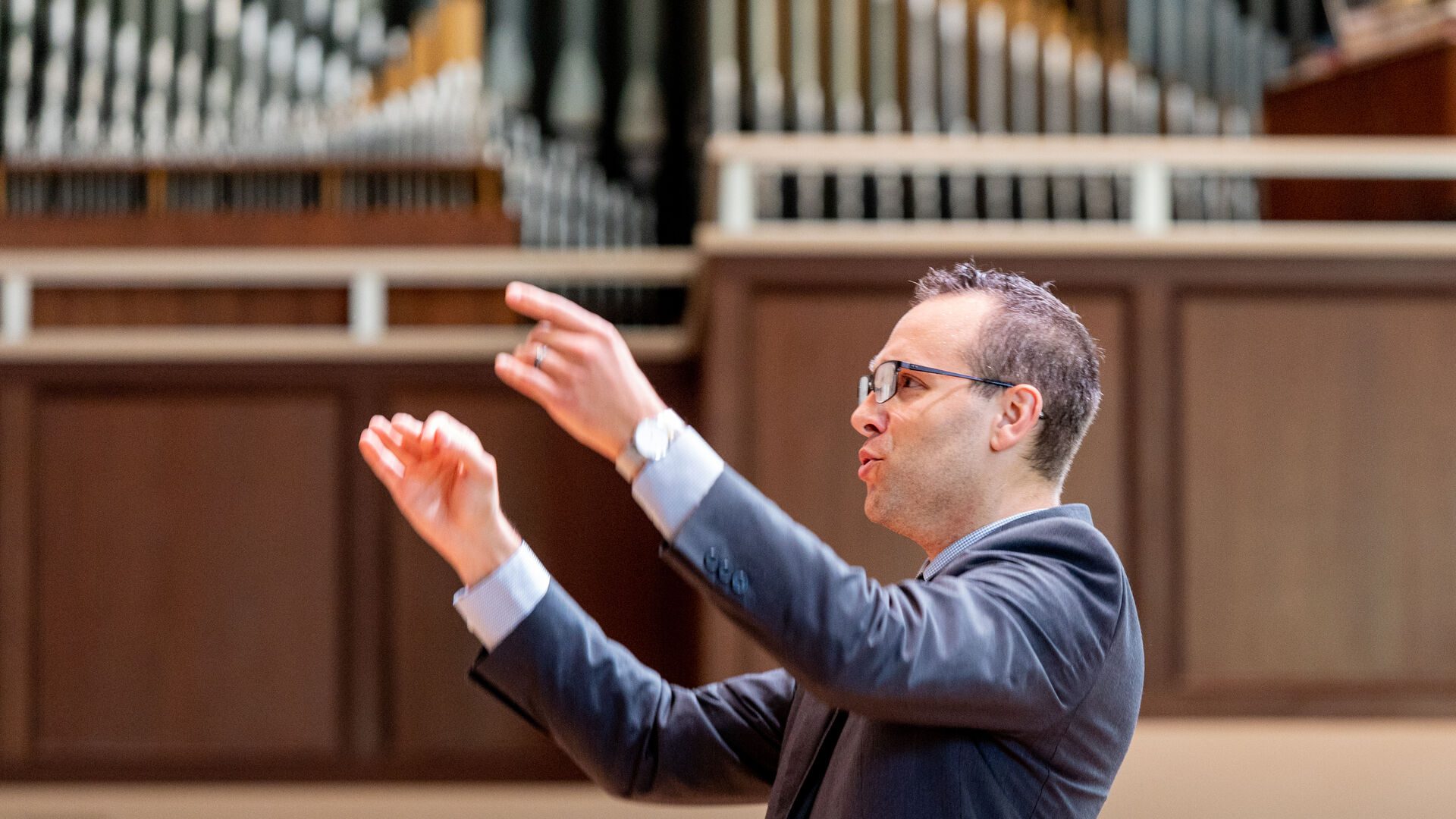Kevin Dibble conducting during Convocation at Houghton University.