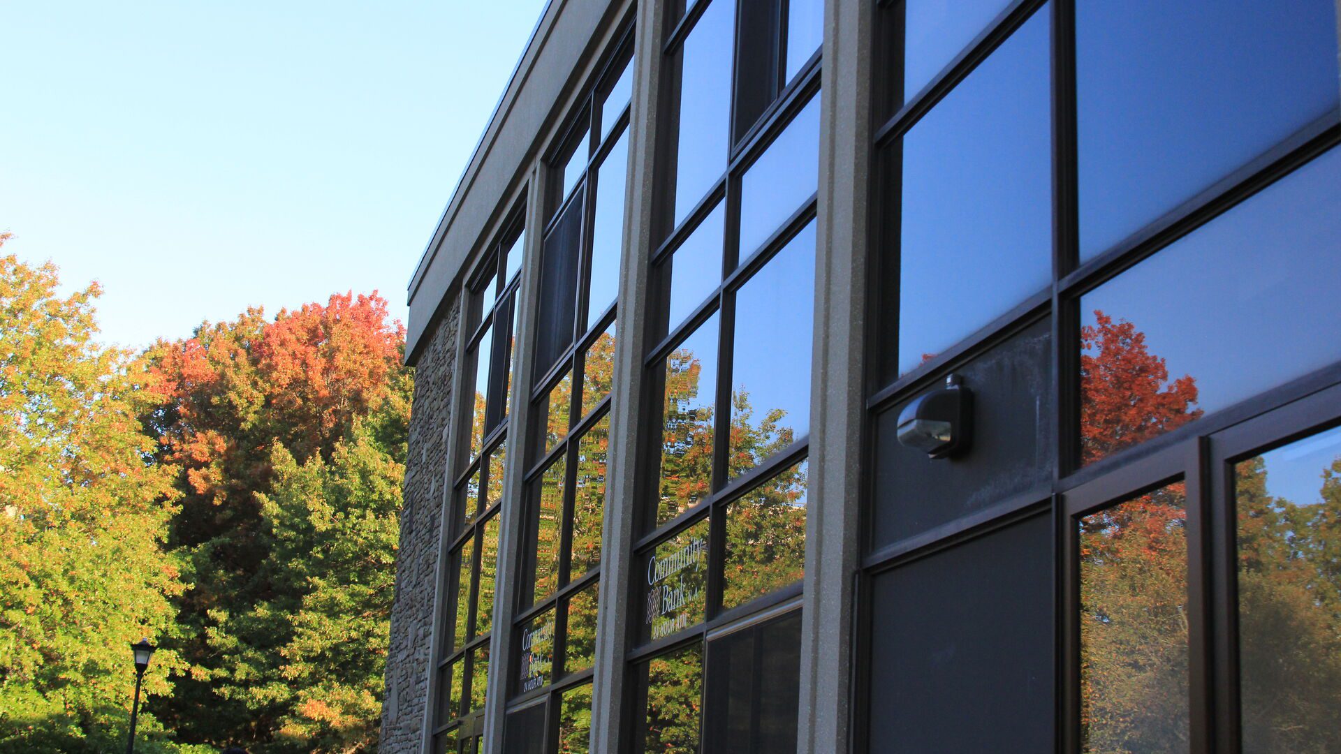Outdoor reflection in the campus center windows during the fall.