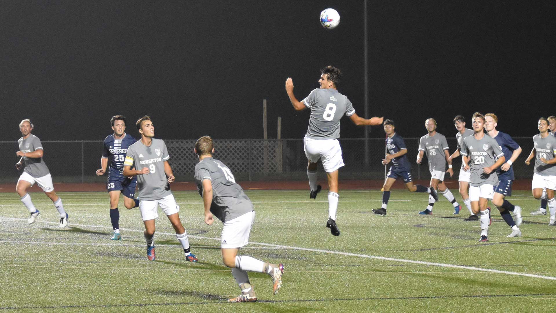 Houghton men's soccer team playing on the field.