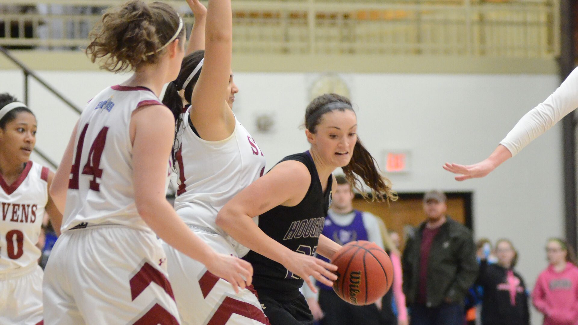 Houghton student holding basketball away from Steven's students.