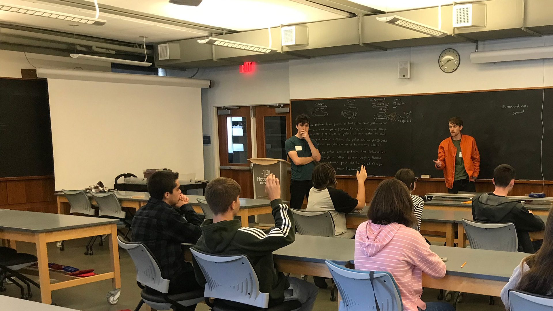 Houghton students working with high school students in on campus lab.