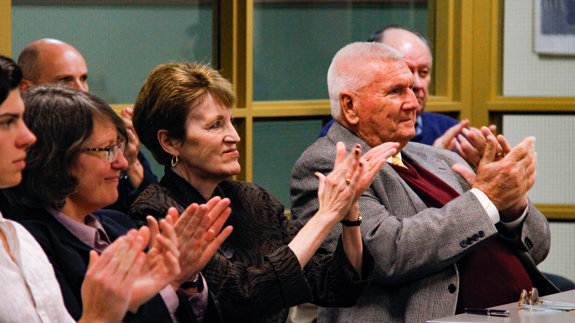 Shirley Mullen, staff and students clapping after lecture at Houghton.