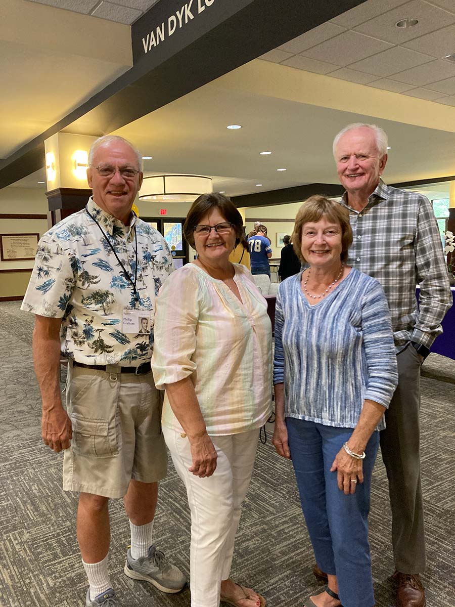 Four Houghton alumni standing together during their class reunion.