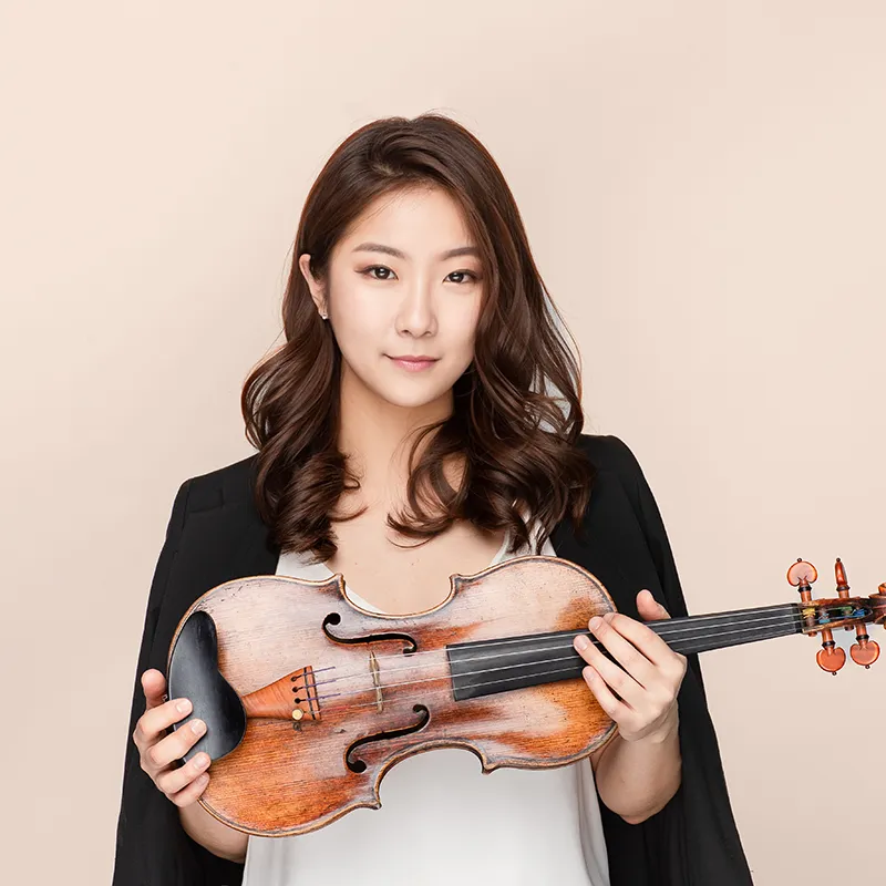 Houghton music faculty member Dr. Soo Yeon Kim holding violin.