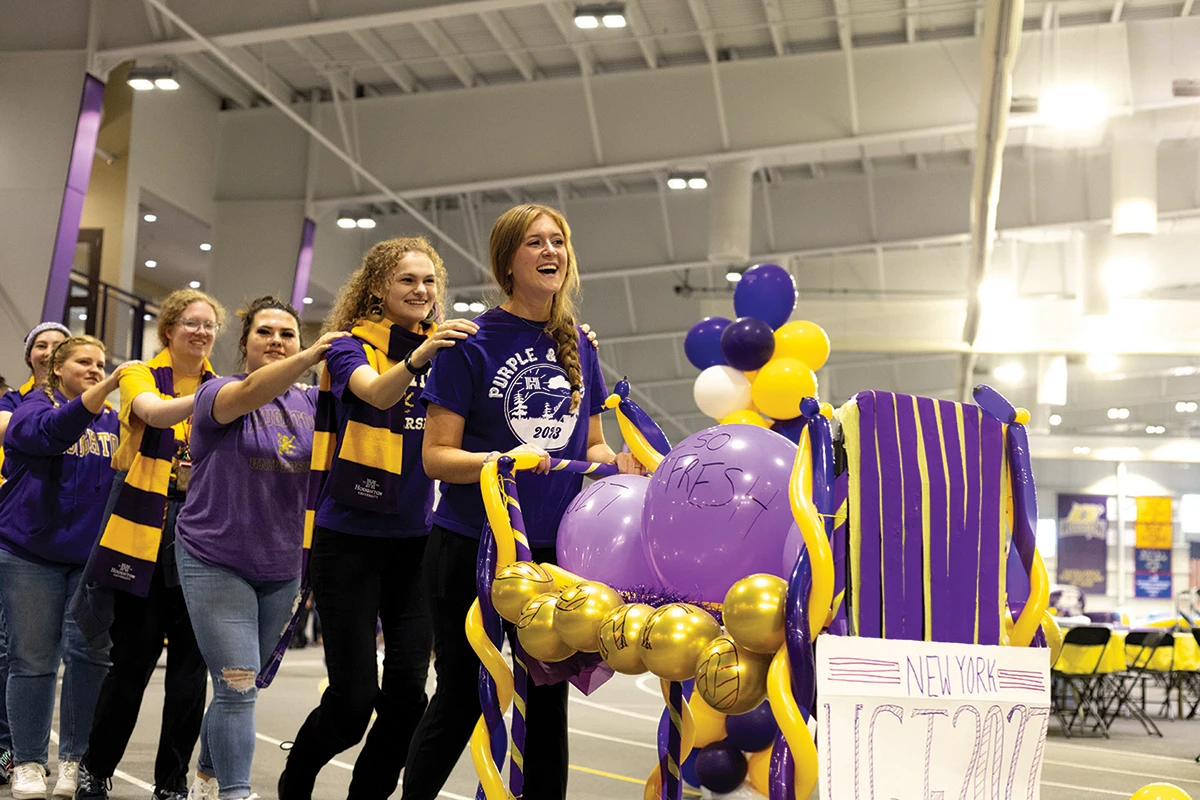 Houghton students walking as a train around the gym during Homecoming.